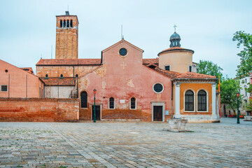 Historic Church of San Giacomo dell Orio with bell tower on quiet square in Venice old town, Italy....
