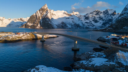 Scenic bridge over fjord with snowy mountains and fishing village in Lofoten, Norway © Andrei Tomas