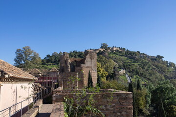 Fototapeta premium Visit to Alkazaba in Malaga, Spain, with historic walls and views of the hilltop landscape