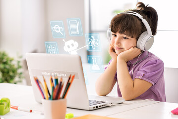 Primary school student using a laptop with virtual AI assistant icons for personalized digital learning at home © StockPhotoPro