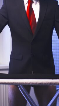 Headless Businessman with red tie iron black pants while wearing boxers 