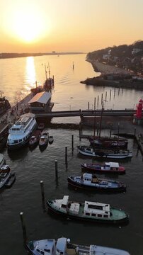 Hamburg Germany 2026 03 09: Aerial drone footage (vertical format) of the Museum Harbor at the Elbe River in Hamburg &Ouml;velg&ouml;nne during magnificent sunset