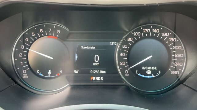 Vehicle instrument cluster with high RPM tachometer reading.
