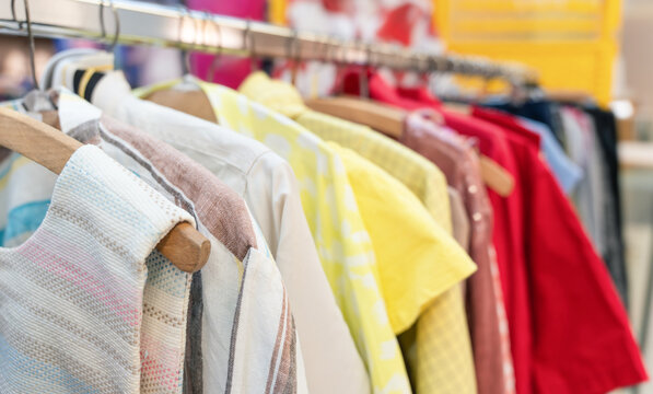 Clothes hanging on rack at sustainable clothing swap event featuring various colors and styles, showcasing eco-friendly fashion choices in a vibrant community setting