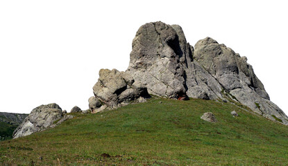Large craggy rock formation on grassy slope isolated on white. PNG file © Maria