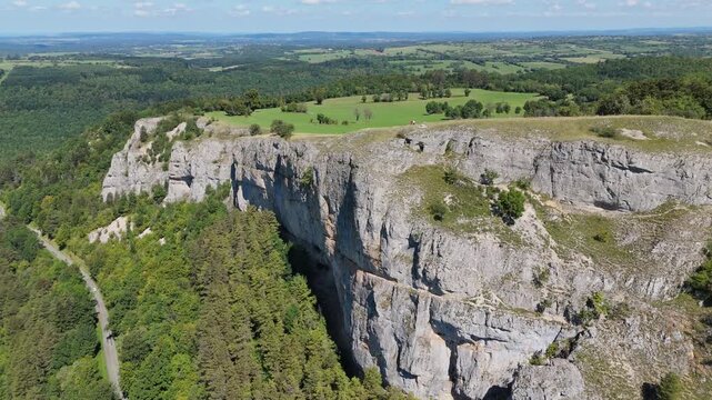 Aerial drone footage of orbiting around the Haute Pierre Mountain in the French Jura near Lods in France