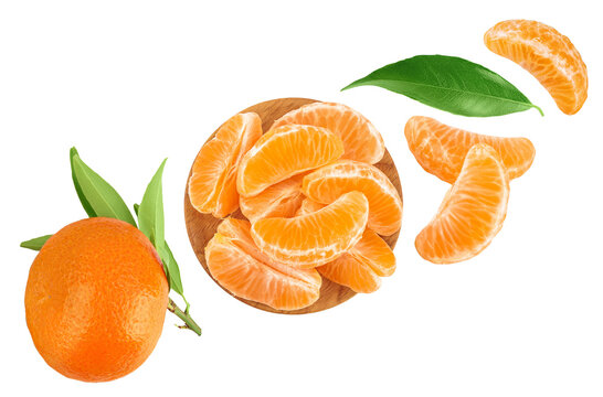 Tangerine or clementine slices in wooden bowl isolated on white background with full depth of field. Top view. Flat lay