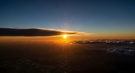 Breathtaking high-altitude sunrise, sunbursting above clouds, illuminating a vast, distant landscape