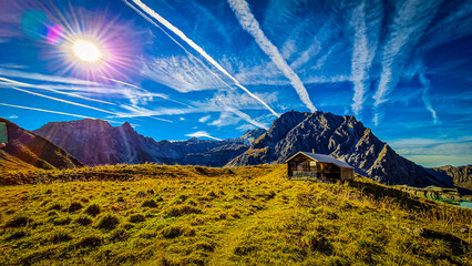 High-Alpine Landscape of Lünersee Reservoir with Turquoise Water and Rugged Mountains in Montafon,...
