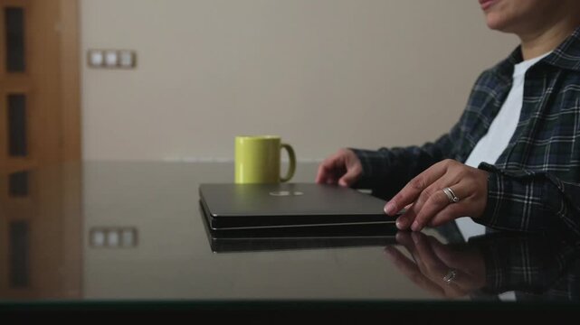 Woman Opening Laptop And Starting Remote Work At Home