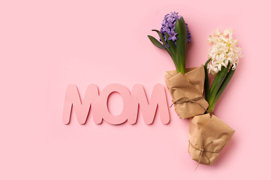Mothers day concept with paper text and hyacinths on pink background, copy space