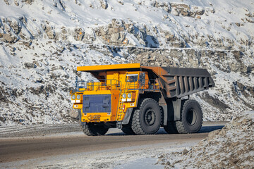 Heavy machinery in action at snowy open-pit coal mine