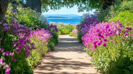 Obraz premium A vibrant path lined with colorful flowers leads to a serene ocean view under a clear blue sky.