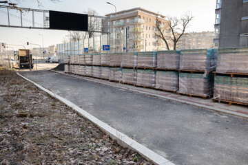 Construction site in an urban environment with laid paving stones and a new path