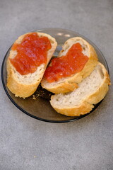 Bread slices with red berry jam on a plate. Healthy food