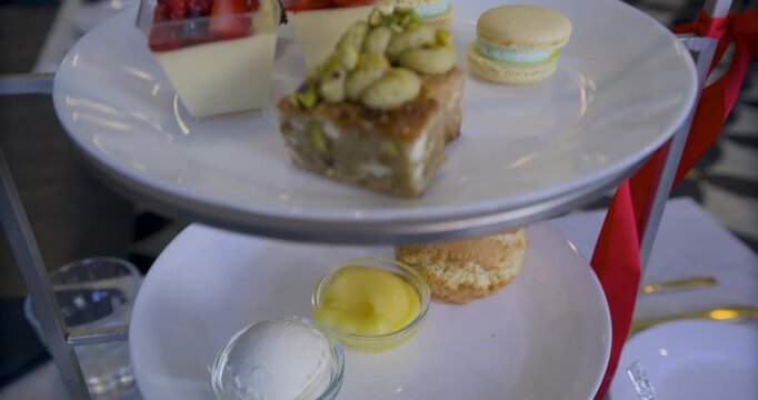 Delicious snacks on tower of plates in restaurant - closeup steady cam movement