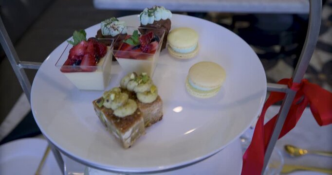 Steady cam movement up tower of plates holding delicious looking snacks