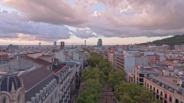 Aerial drone flying over barcelona's rambla de catalunya at sunset