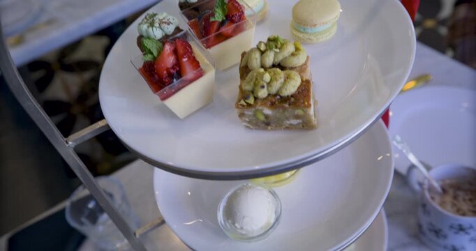 Steady cam close up moving up on stack of plates with snacks