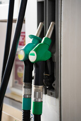 Petrol pump nozzles at service station. Fuel pump nozzles at gasoline station