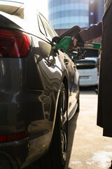 Fuel pump inserted into car tank at gas station © Rabizo Anatolii