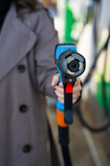 Hand holding gas pump nozzle during LPG car refueling © Rabizo Anatolii