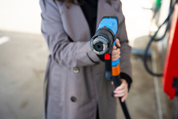 Driver refilling vehicle with LPG fuel using pump nozzle © Rabizo Anatolii