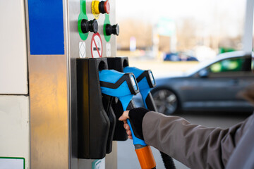 Refueling car with hand on LPG pump nozzle © Rabizo Anatolii