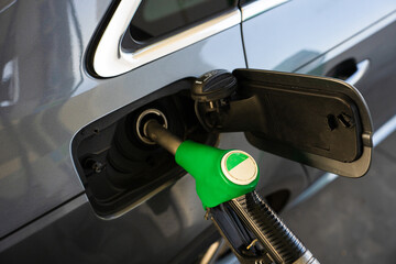 Fuel pump inserted into tank during refueling. Close-up refilling vehicle with gasoline © Rabizo Anatolii