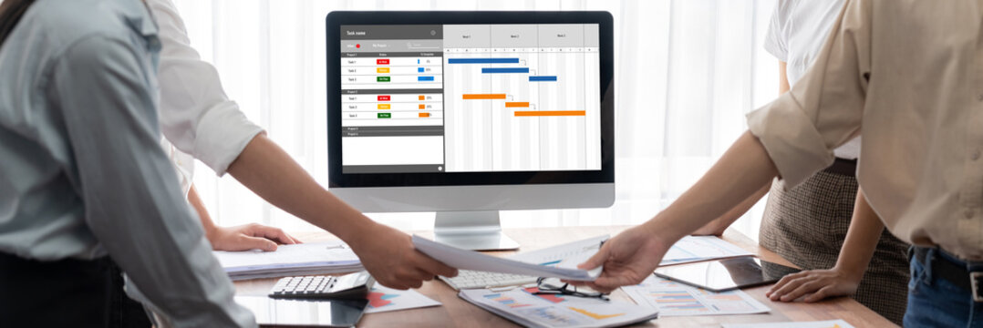 Project planning software for brisk business project management on the computer screen showing timeline chart of the team project