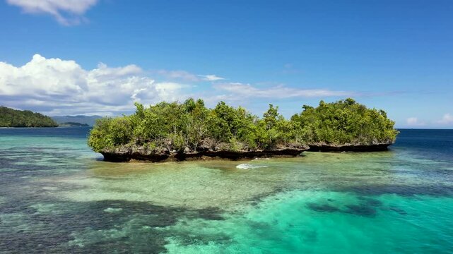 Aerial Fly-By Over Forested Islets and Coral Reef, Gam Islands, Raja Ampat Indonesia
