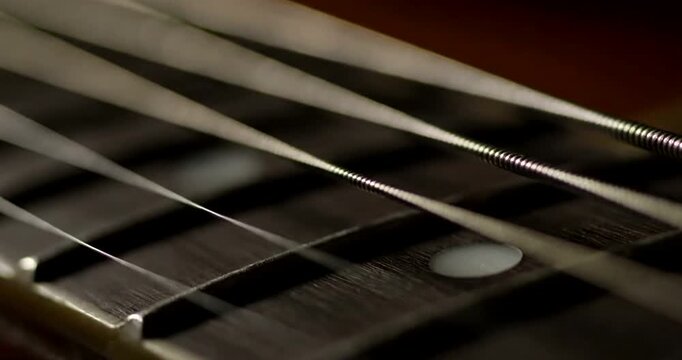 Close up of guitar strings.