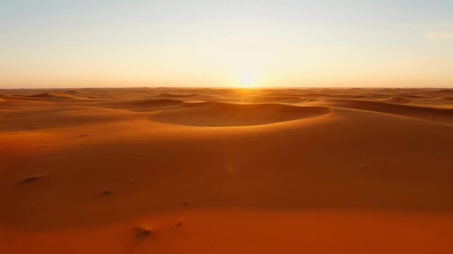 Golden sunset over endless sand dunes in the arid desert landscape