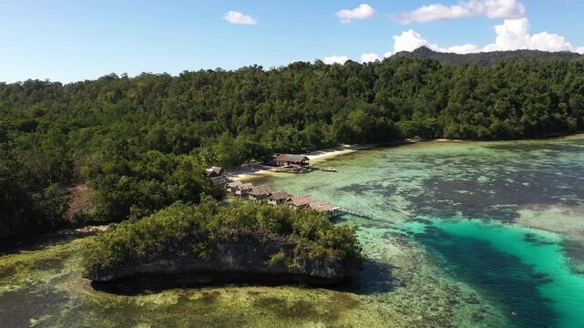 Aerial View of Overwater Huts Above Coral Reef, Gam Island Raja Ampat Indonesia