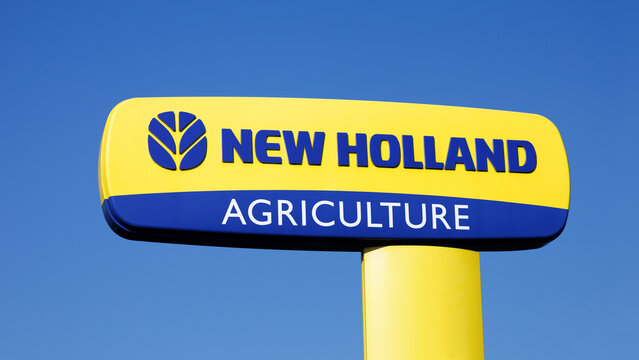 Radziejow, Poland - March 9, 2026. New Holland logo on a pylon - New Holland is a global manufacturer of agricultural machinery.