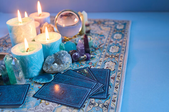 Tarot cards, crystals, and candles for divination
