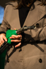Hand holding gasoline nozzle at fuel station close-up. Driver refueling car using gasoline pump © Rabizo Anatolii