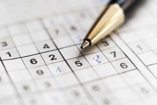 Solving Sudoku Puzzle with Pen Close Up