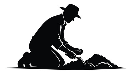 Man kneeling and digging in the dirt with a shovel © SILHUETTECHEMBER