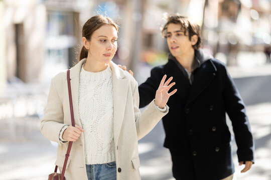 Attempt to meet and find love. Chance encounter between young strangers in park. Guy is trying to get to know girl. Guy is rejected while trying to pick up girl at street outdoor.