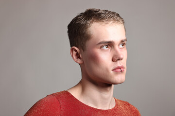 Obraz premium Young man with piercing on light grey background