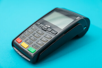 Obraz premium One payment terminal on light blue background, closeup