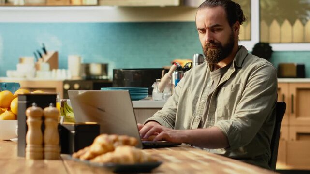 Disoriented man being preoccupied with task apprehension at home, struggling and frowning at laptop. Freelancer confused and uncertain trying to fix error, telework misunderstanding.