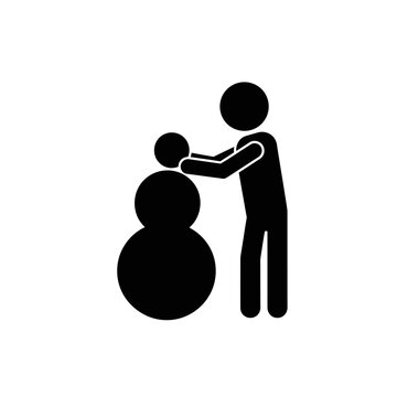 Person Building Snowman in Winter.