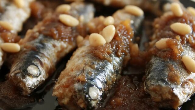 Close Up View of Delicious Cooked Fish with Rich Brown Sauce and Pine Nuts.