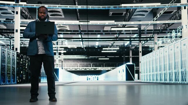 Team of server farm software developers using laptop to optimize electronics. Data center teamworking colleagues brainstorming, using notebook to monitor system performance bottlenecks, camera A