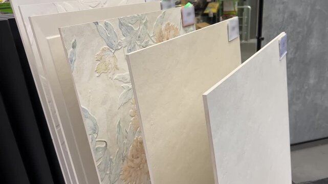 Large Format Ceramic Wall Tiles on Display in Building Materials Store | Collection of Decorative and Plain Beige Tiles with Floral Pattern | Interior Design Showroom