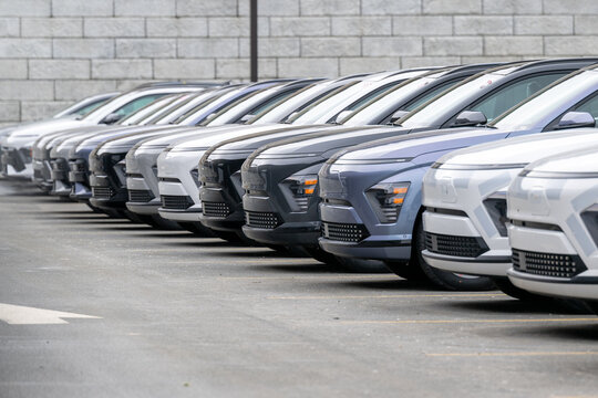 Orlando, Florida, US-March 20, 2026: A Hyundai dealership parking lot has a row of new sporty KONA electric SUV vehicles for sale. The inventory stock is white, blue, black, and grey colored cars.