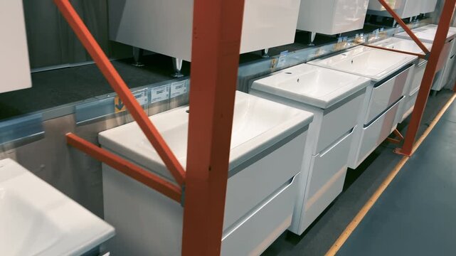 Row of White Ceramic Bathroom Sinks with Vanity Cabinets on Display in Store | Modern Wall-Mounted Washbasin Units Collection | Sanitary Ware Showroom