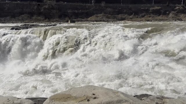 Pan shot from upstream to Hukou Waterfall, stunning natural scenery.